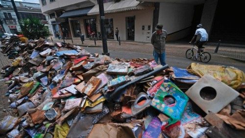 Thousands of damaged books are seen on the street after heavy rains flooded the bookstore in ...