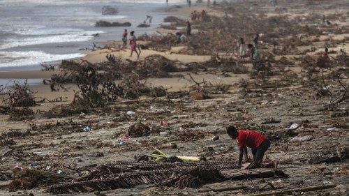 FILE PHOTO: A boy searches among debris on the beach, in the aftermath of Cyclone Batsirai, in the ...