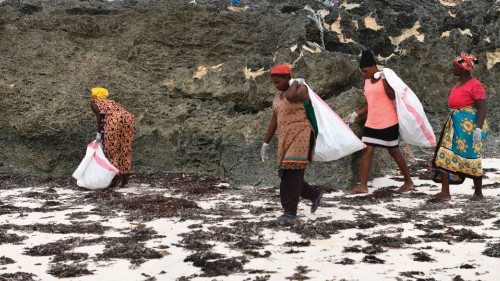Volunteers collect plastic waste during a cleaning exercise organized by Ocean Sole Africa, in ...