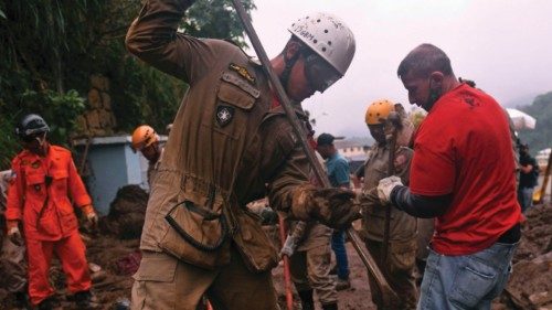 Firefighters and volunteers are seen during a rescue mission after a giant landslide at Caxumbu ...