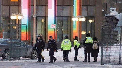 Police members stand at a checkpoint after Canadian police evicted the last of the trucks and ...