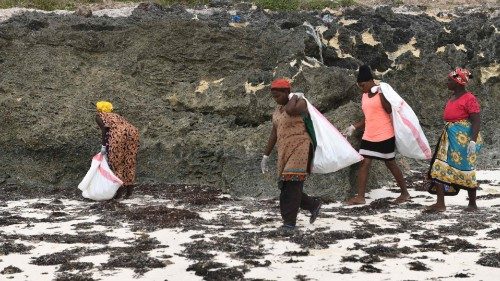 Volunteers collect plastic waste during a cleaning exercise organized by Ocean Sole Africa, in ...
