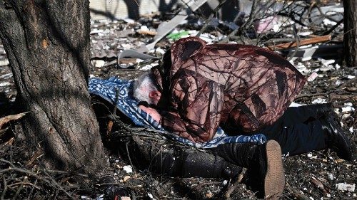 TOPSHOT - A man reacts at the body of a relative outside a destroyed building after bombings on the ...