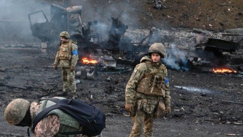 TOPSHOT - Ukrainian service members look for and collect unexploded shells after a fighting with ...