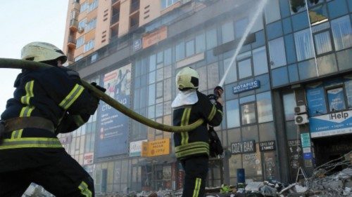 Firefighters extinguish fire in an apartment building damaged by recent shelling in Kyiv, Ukraine ...