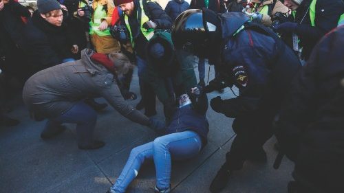 TOPSHOT - Police officers detain a demonstrator during a protest against Russia's invasion of ... TOPSHOT - Police officers detain a demonstrator during a protest against Russia's invasion of ...
