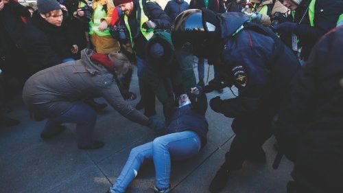 TOPSHOT - Police officers detain a demonstrator during a protest against Russia's invasion of ...