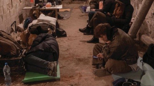 Residents take shelter in the basement of an apartment building, after Russia launched a massive ...