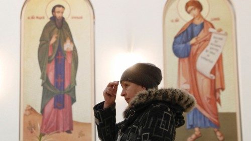 A believer attends a liturgy at the Ukrainian Catholic Cathedral of the Resurrection of Christ in ...