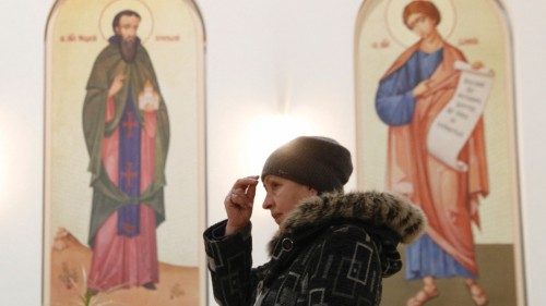 A believer attends a liturgy at the Ukrainian Catholic Cathedral of the Resurrection of Christ in ... A believer attends a liturgy at the Ukrainian Catholic Cathedral of the Resurrection of Christ in ...