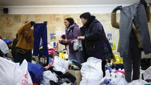 Volunteers sort through supplies donated by members of the public that are destined for internally ...