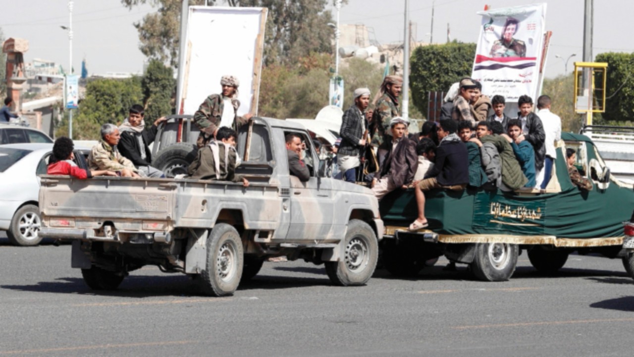 epa09791834 Armed Houthi fighters ride vehicles during a mass funeral of 15 slain Houthi fighters ...