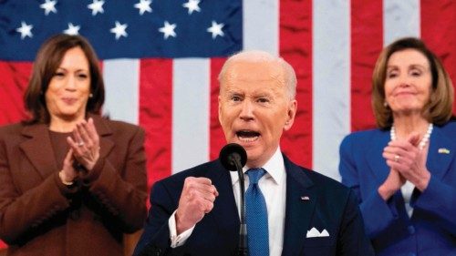 TOPSHOT - US President Joe Biden gestures, applauded by US Vice President Kamala Harris (L) and US ...
