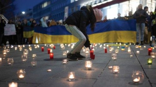 epa09792316 People light candles to form a sea of lights as they attend a support vigil for Ukraine ...