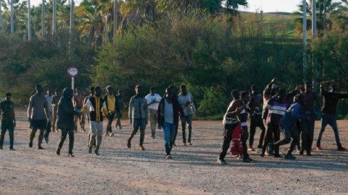 epa09798403 Dozen of migrants celebrate after they managed to jump Spanish-Moroccan border in the ...