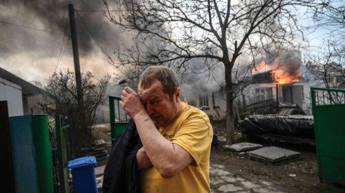 Yevghen Zbormyrsky, 49, reacts in front of his burning house after being shelled in the city of ...