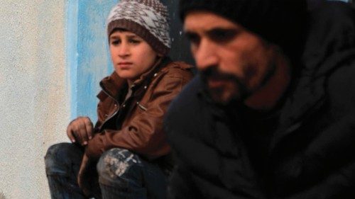 Internally displaced Syrians unload their belongings from trucks upon arrival at a new housing ... Internally displaced Syrians unload their belongings from trucks upon arrival at a new housing ...