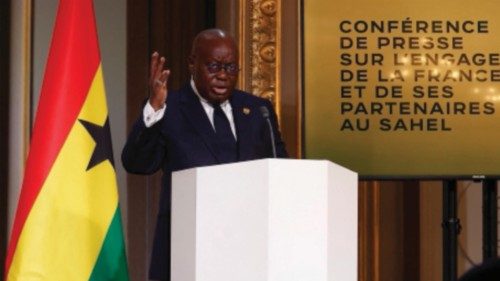 French President Emmanuel Macron (L), with Ghana's President Nana Afuko Addo (R), holds a joint ...