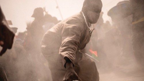 A man sweeps the ground as an allegory for the departure of French troops  during a demonstration ...