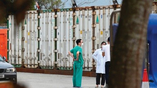 Medics chat between refrigerated containers to hold Covid-19 coronavirus victims at the Fu Shan ...