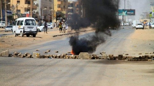 Sudanese protesters block a road with bricks during a demonstration of 'mothers and fathers' in the ...