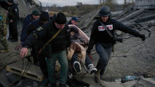A person is carried, as Russia's invasion of Ukraine continues, in Romanivka, Ukraine, March 9, ...