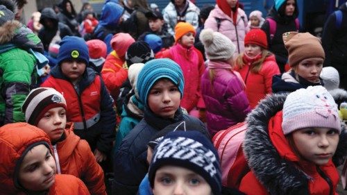 A group of children evacuated from an orphanage in Zaporizhzhia wait to board a bus for their ...