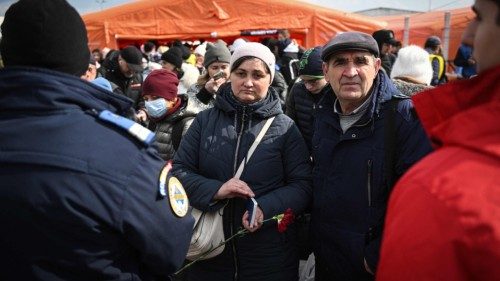 Ukrainian refugees wait for their documents check by the Romanian authorities (L), upon arrival at ...