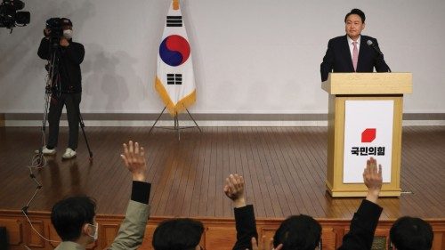 Media members raise their hand to ask questions as South Korea's president-elect Yoon Suk-yeol (R) ...