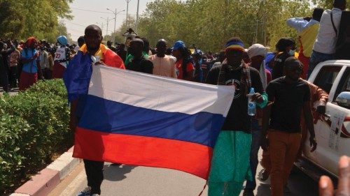 A Russian flag is carried during a demonstration in N'Djamena on February 26, 2022 called by the ...