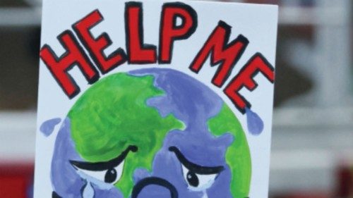 FILE PHOTO: People carry a sign as they attend a protest during the UN Climate Change Conference ...