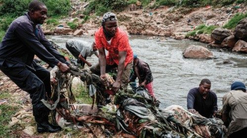 Members of the local voluntary group, the Canaan Riverside Green Peace, remove debris from the ...