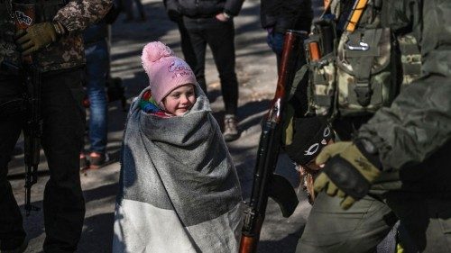 A child wait to be evacuated from the city of Irpin, north of Kyiv, on March 10, 2022. - Russian ...