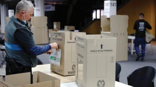 epa09818023 Workers prepare the voting tables inside Corferias in Bogota, Colombia 11 March 2022. ...