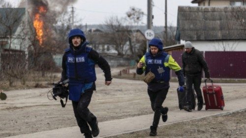 Journalists run for cover after heavy shelling on the only escape route used by locals, while ...
