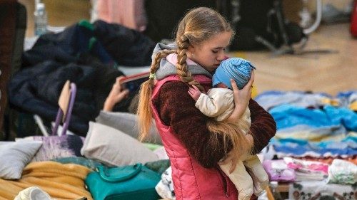TOPSHOT - A girl holds her sibling in a temporary shelter for Ukrainian refugees in a school in ... TOPSHOT - A girl holds her sibling in a temporary shelter for Ukrainian refugees in a school in ...