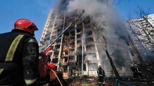 Firefighters extinguish a fire in a 16-storey residential building in Kyiv on March 15, 2022, after ...