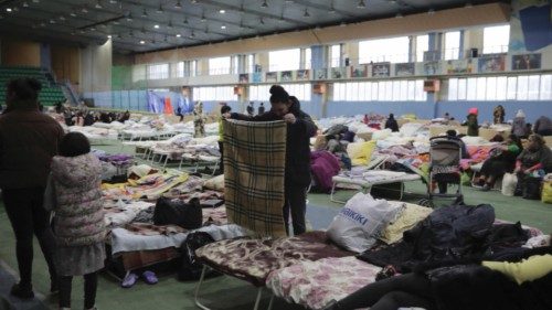 epa09825587 Ukrainian refugees temporarily housed at the Manege Chisinau Sports Arena Center prepare ...