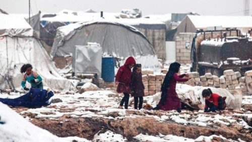 Children play in the snow at a camp for internally displaced Syrians, near the town of Kafr Lusin, ...