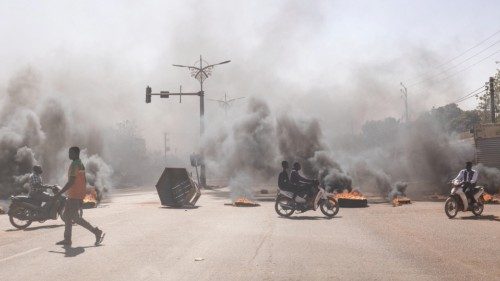 A man crosses through burning barricades in the central avenues in Ouagadougou where group of young ...