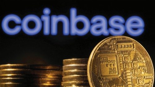 FILE PHOTO: A representation of the cryptocurrency is seen in front of Coinbase logo in this ...