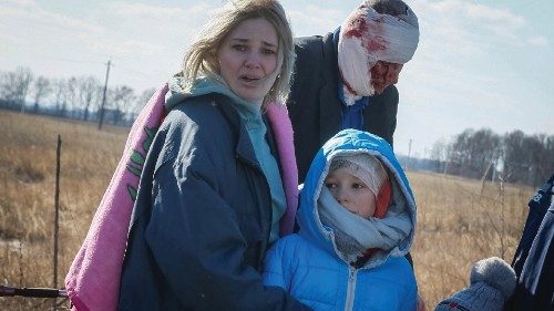 People react as they evacuate from a village occupied by Russian troops on the front line, in the ...