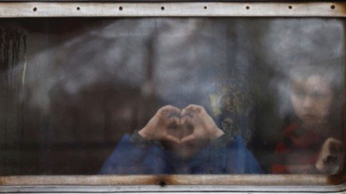 Children look on from a train window as they arrive in a Ukrainian train from Lviv that is ...