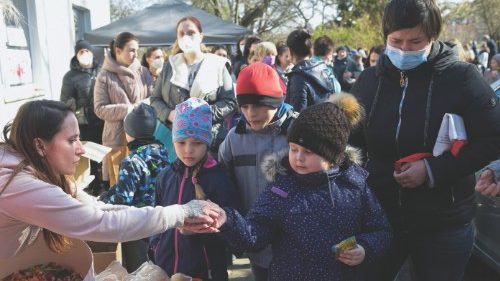 Refugees from Ukraine queue for food at a donation collection point organised by the Dresden`s ...