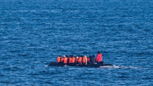 TOPSHOT - Migrants wearing life jackets sit in a dinghy as they illegally cross the English Channel ...