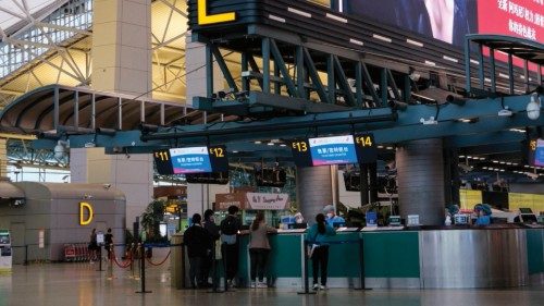 Passengers line up at the check-in counter of China Eastern at Guangzhou Baiyun International ...