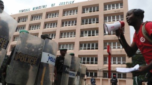 A man address riot policemen during a protest to commemorate one year anniversary of EndSars, a ...