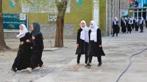 Girls arrive at their school in Kabul on March 23, 2022. - The reopening of secondary schools for ...