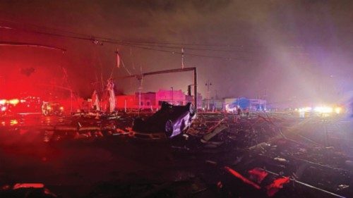 A car lies overturned among debris in the Arabi neighborhood after a large tornado struck New ...