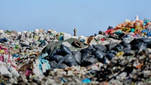 A waste picker stands at the crest of a mound of plastic and other waste at the Dandora garbage dump ...